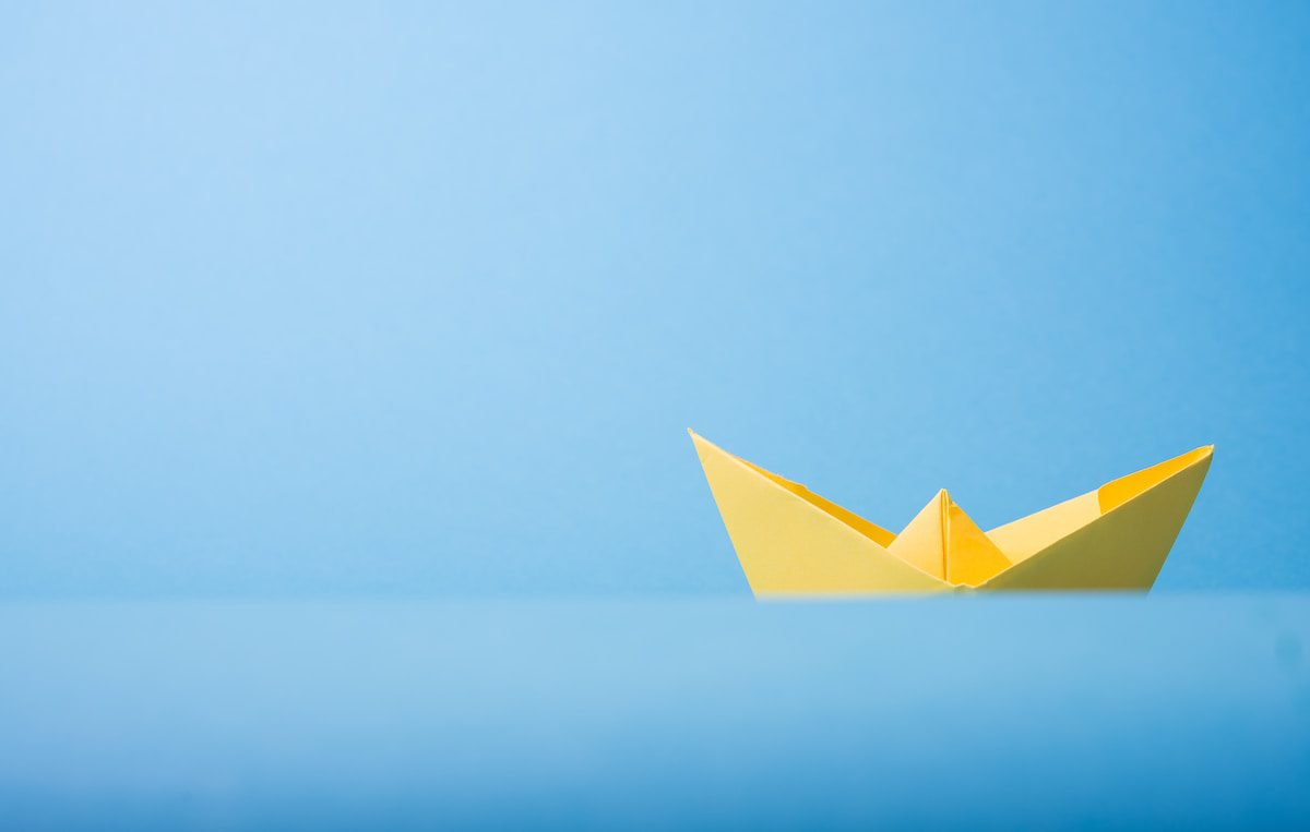 closeup photo of yellow paper boat - Unique Paper Goods