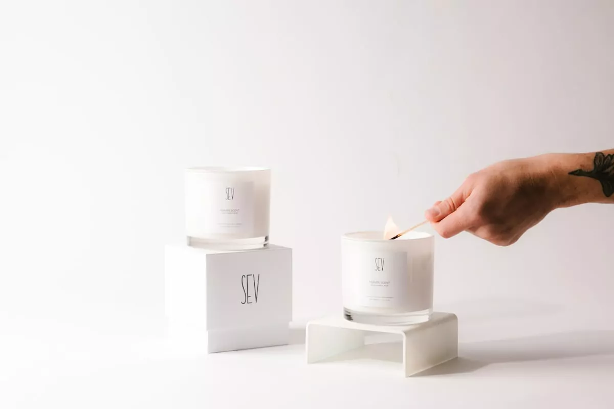 person holding white candle holder - Candles
